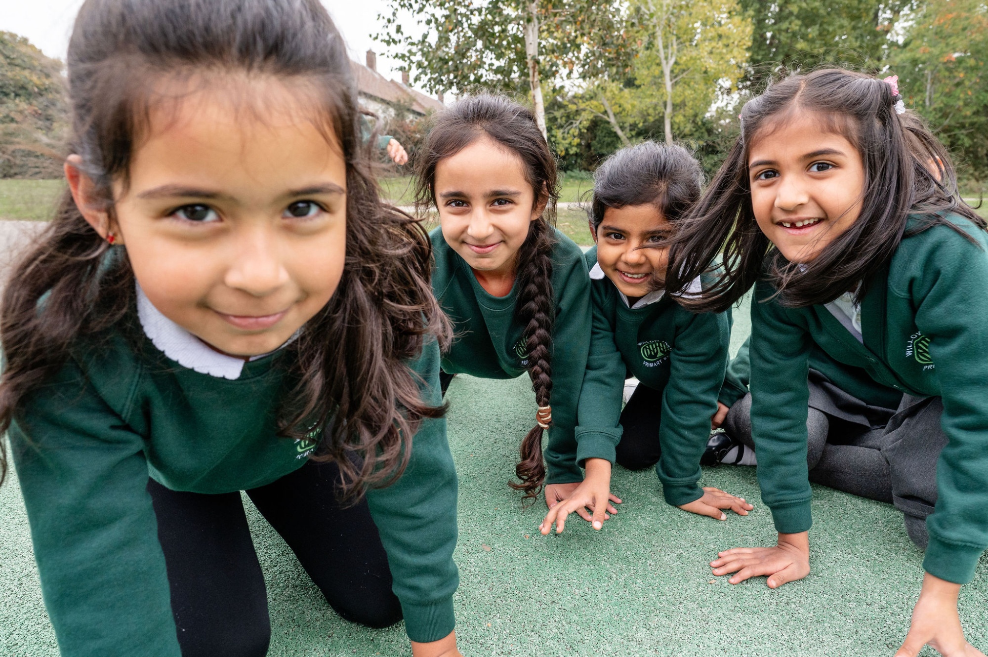 3 children look at something they've found in the woods